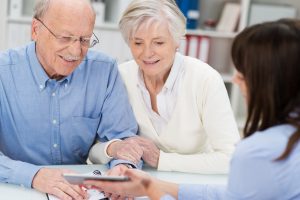 An elderly couple writing a Will with the help of a Will writer